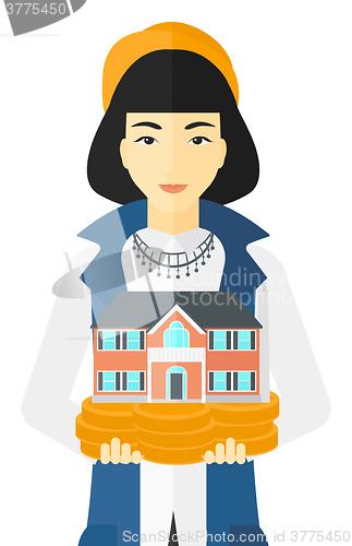 Image of Woman holding house model.