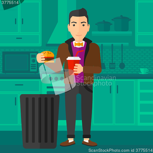 Image of Man throwing junk food.
