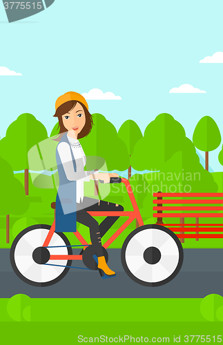 Image of Woman riding bicycle.