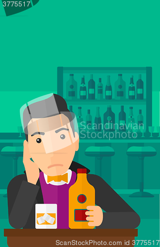 Image of Sad man with bottle and glass.