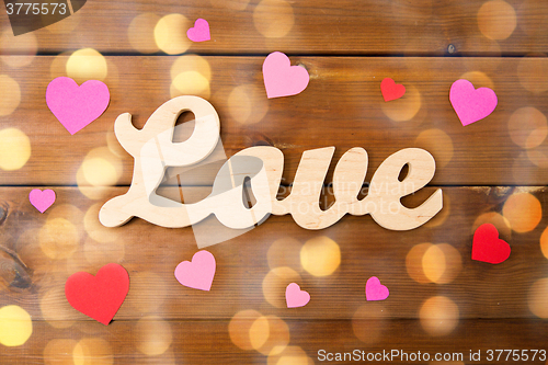 Image of close up of word love with red paper hearts