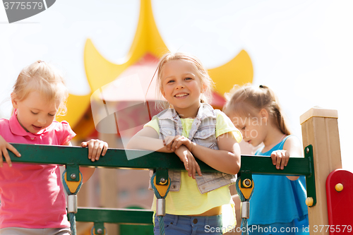 Image of happy little girls on children playground