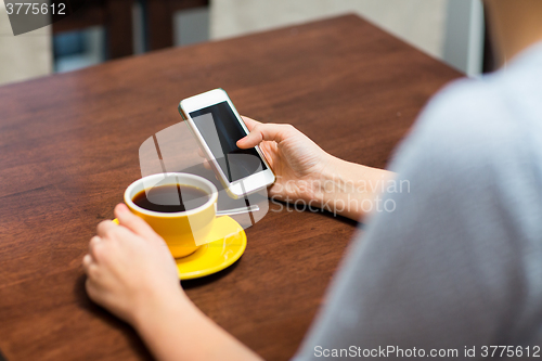 Image of close up of woman with smartphone and coffee