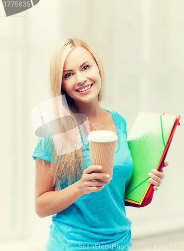 Image of smiling student with folders