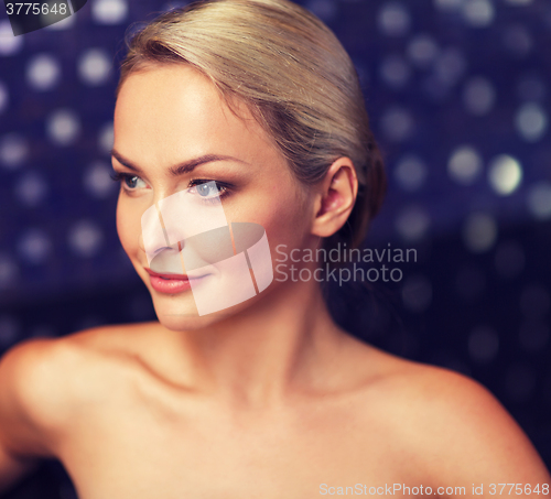 Image of close up of young woman sitting in bath towel