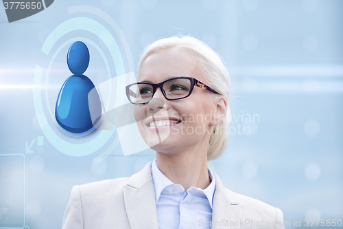 Image of young smiling businesswoman in eyeglasses outdoors