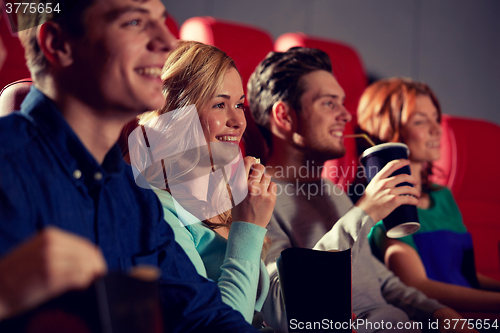 Image of happy friends watching movie in theater