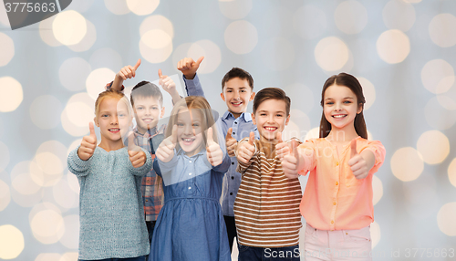 Image of happy children showing thumbs up