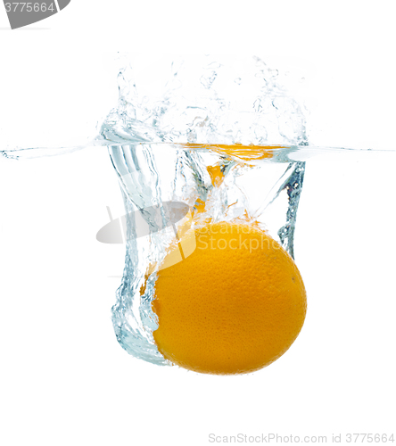 Image of orange falling or dipping in water with splash