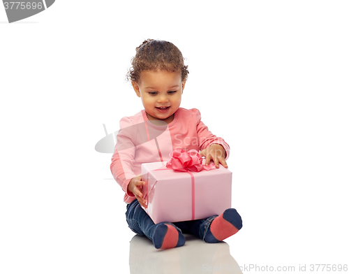 Image of happy little baby girl with birthday present