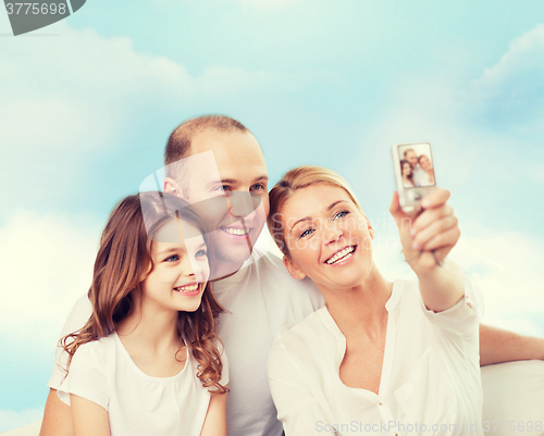 Image of happy family with camera at home