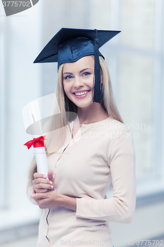 Image of student in graduation cap with certificate