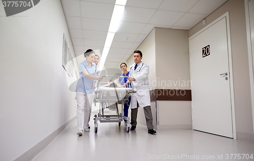 Image of medics and patient on hospital gurney at emergency