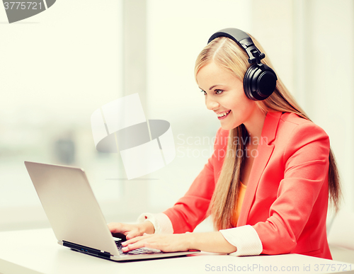 Image of happy woman with headphones listening to music