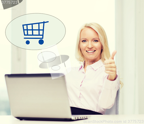 Image of happy businesswoman with laptop showing thumbs up