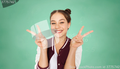 Image of happy teenage student girl showing peace sign