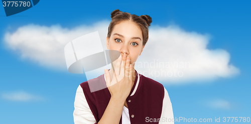 Image of confused teenage girl covering her mouth by hand