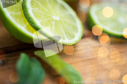 Image of lime slices on wooden table