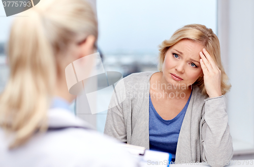 Image of smiling doctor and woman meeting at hospital