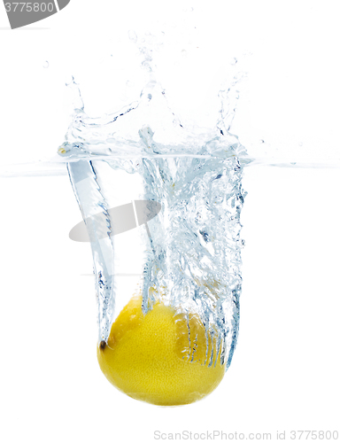 Image of lemon falling or dipping in water with splash