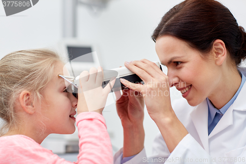 Image of optician with pupilometer and patient at eye clinic