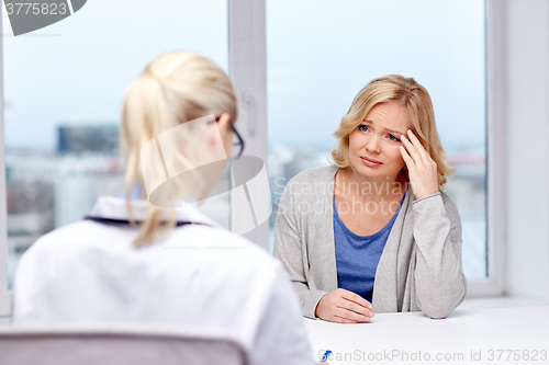 Image of smiling doctor and woman meeting at hospital