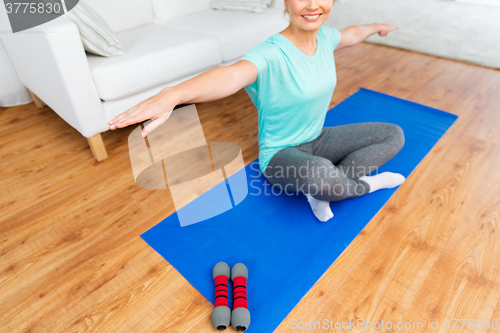Image of close up of woman exercising on mat at home 