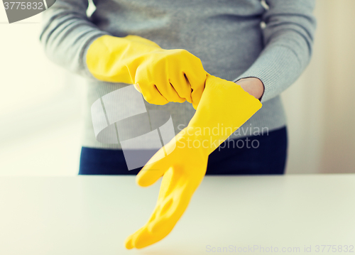 Image of close up of woman wearing protective rubber gloves