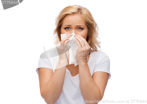 Image of unhappy woman with paper napkin blowing nose