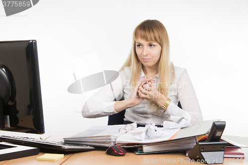 Image of Director of the office mischief crumples paper document and looking at the monitor screen