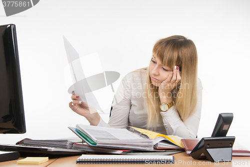 Image of Tired office of a specialist reading the paper document