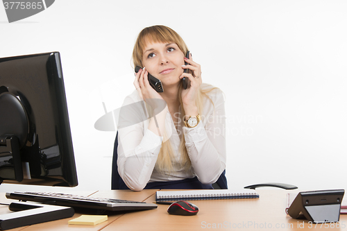 Image of Secretary talking on two phones at once - and the working cell