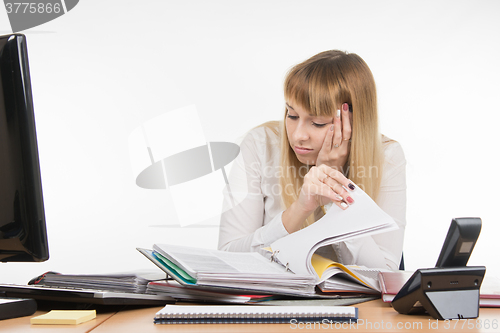 Image of Tired falls asleep digging a specialist office folders with documents