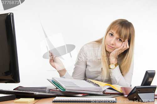 Image of Office a specialist tired to dig into the folders with documents