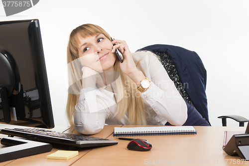 Image of Happy business woman having fun talking on a cell phone in the office