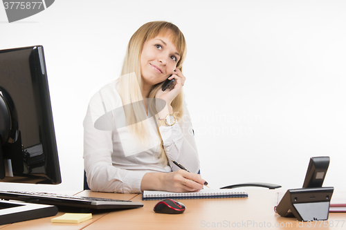 Image of Happy business woman flirts talking on a mobile phone