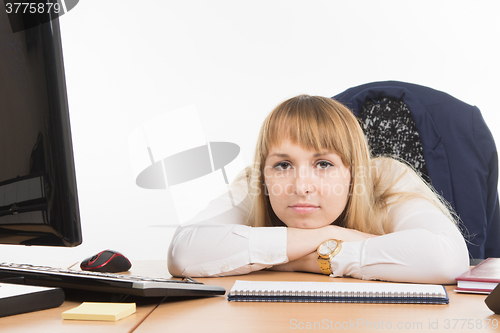 Image of Sad office a specialist lay on the desktop