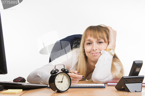 Image of Tired office employee tries to schedule the working day