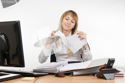 Image of Business girl having fun tearing the paper document