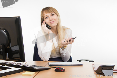 Image of Happy secretary talking on the phone and working holding cell