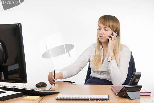 Image of Business woman holding business talks on a mobile phone