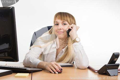 Image of Business woman happy talking on a cell phone in the workplace