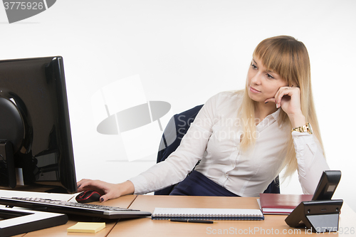 Image of Office a specialist a little tired of working at a computer