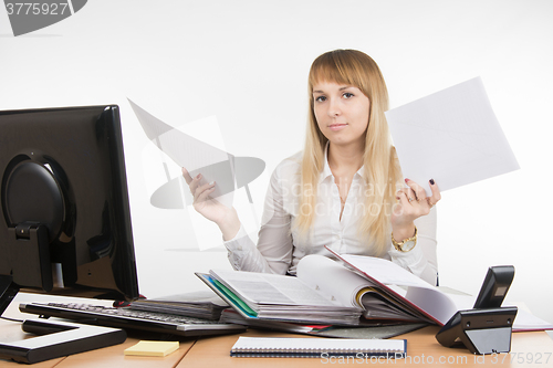 Image of Office Specialist sorts the documents in a folder