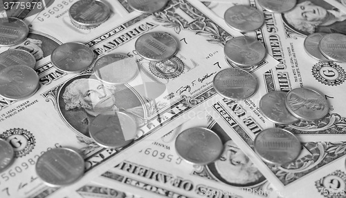 Image of Black and white Dollar coins and notes