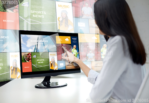 Image of close up of woman with news on computer in office