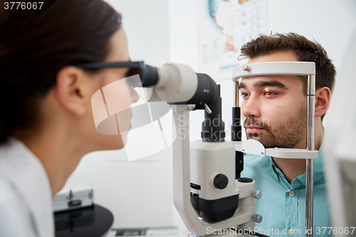 Image of optician with tonometer and patient at eye clinic