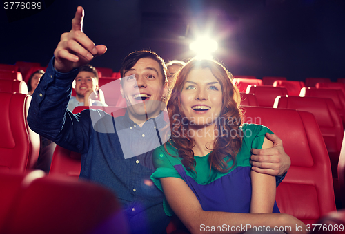 Image of happy friends watching movie in theater