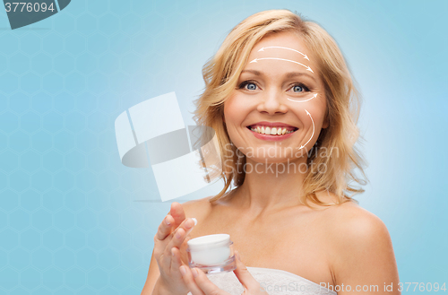 Image of happy woman with cream jar