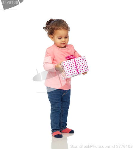 Image of beautiful little baby girl with birthday present